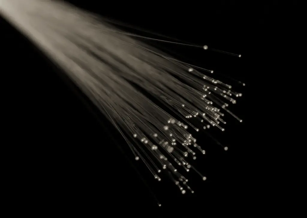 Strands of optical fibre glowing at their tips