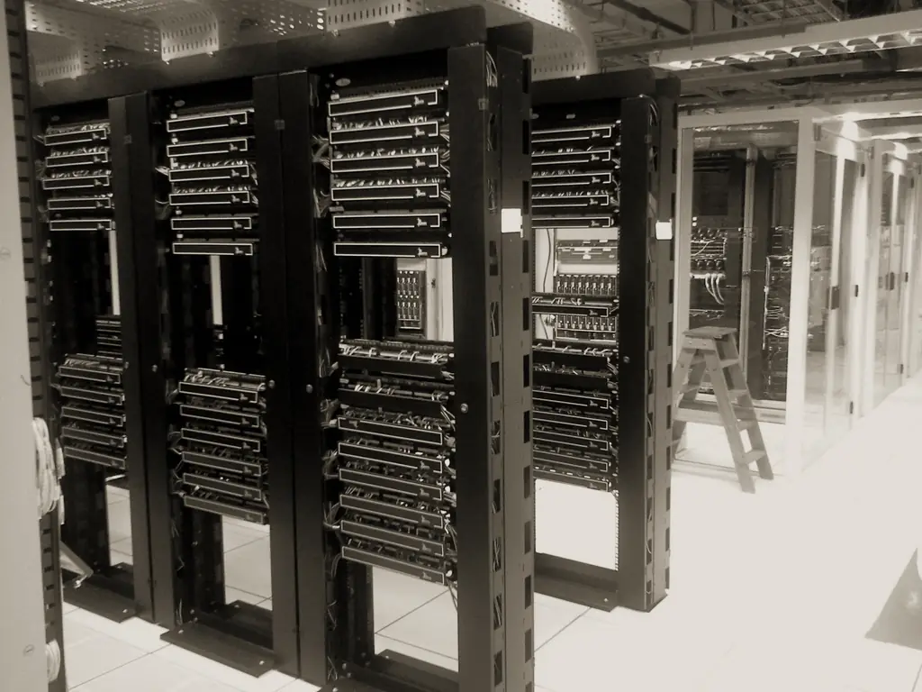 Rows of server racks with network cabling in a data centre